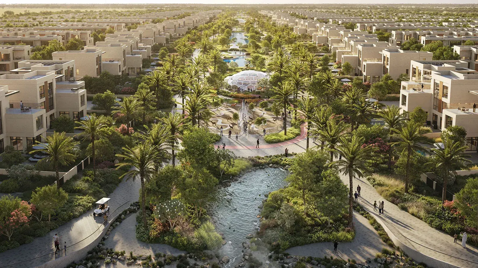 Aerial view of palm-lined villas, a biodome and a landscaped water channel in Sharjah Sustainable City