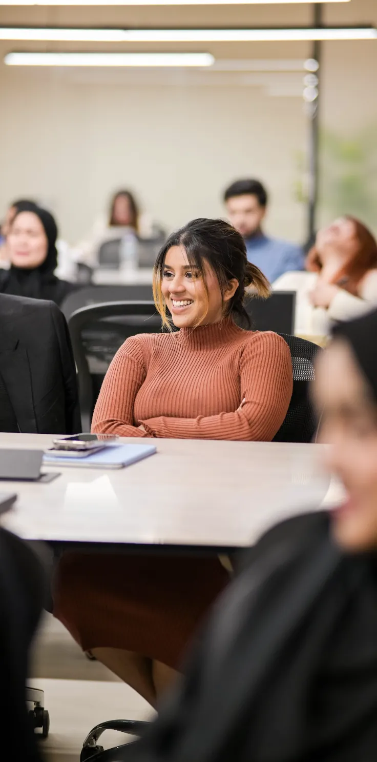 A Keyspace colleague smiling during a team meeting in the office